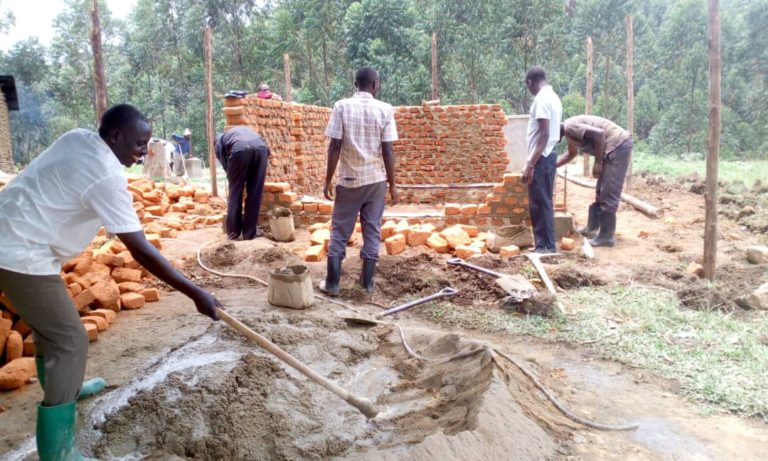 Work teams from KEC building the wall